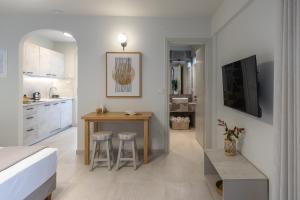 a kitchen and dining room with a table and a bed at One Bedroom Apartment Erato in Argostoli