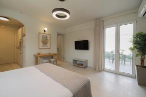a bedroom with a bed and a large window at One Bedroom Apartment Erato in Argostoli