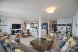 a large living room with a couch and a table at White-Blue Luxury Villa 2 in Pefkali