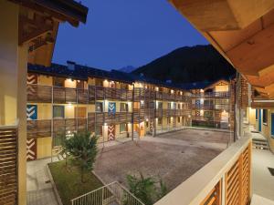 a view of the courtyard of a resort at night at Residence Adamello Resort in Ponte di Legno