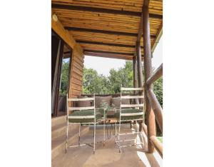 a screened in porch with two chairs and a table at Mua Hills Getaway in Katelembu