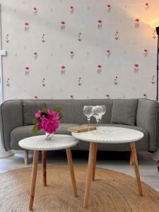 a living room with two tables and a couch at Chez Suzanne in Saint-Père-sur-Loire +16 photos