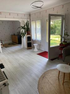 a living room with a door open to a living room at Chez Suzanne in Saint-Père-sur-Loire