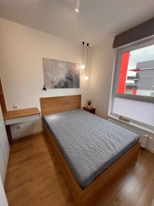 a bedroom with a bed and a window at Fordon BLUE 61 z sypialnią in Bydgoszcz +5 photos