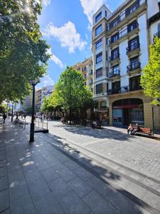 a street in a city with buildings and trees at Pension Lorea in San Sebasti&aacute;n