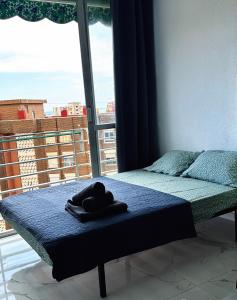 Ένα ή περισσότερα κρεβάτια σε δωμάτιο στο Plaimon Apartamento - estudio