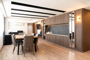 a dining room with a table and chairs and a chalkboard at indigo Hotel Hatyai 1 Phet Kasem Road in Hat Yai