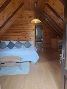 a bedroom with a bed and a wooden ceiling at Guesthouse Andrea in Poljanak