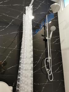 a bathroom with a shower with a glass shower curtain at Pool Villa Mountainview in Cha Am