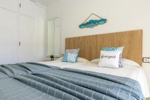 a bedroom with two beds with blue and white sheets at NOVELTY III Arysal 3 in Salou +29 photos