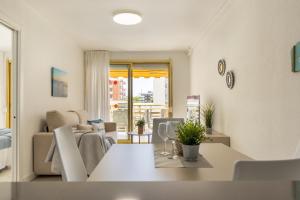 a living room with a table and a couch at NOVELTY III Arysal 3 in Salou