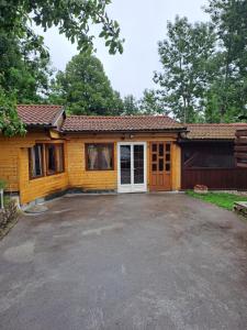 a house with a large driveway in front of it at Guesthouse Andrea in Poljanak