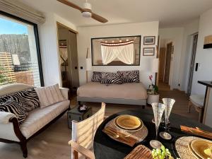 a living room with a couch and a table at le lodge Saint Clair in Sète