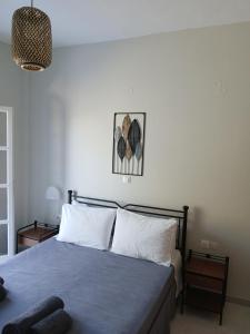 a bedroom with a blue bed with white pillows at Andromeda in Ios Chora