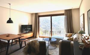 a living room with a couch and a table at BOJ Casas de Montaña in Bielsa