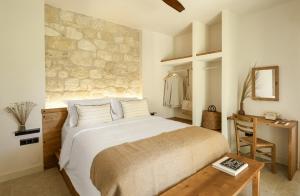 a bedroom with a large white bed and a desk at Ergon Beach House Nikiti in Nikiti