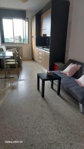 a living room with a couch and a coffee table at #Punto FM 5# in Campalto +40 photos