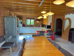 a kitchen with a couch and a table and a refrigerator at Amandi in Hotton