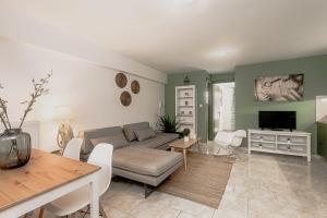 a living room with a couch and a table at K Houses I4 in Lefkada