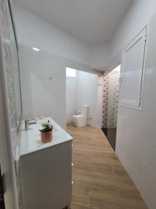 a white bathroom with a sink and a toilet at Alojamientos Agaete Pueblo Nº3 in Agaete