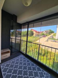 a room with a balcony with a view of a street at Somad Apartment in Rediu