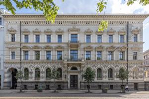 a large white building with many windows at The Benjamin House in Rīga