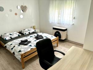 a bedroom with a bed and a chair in it at Apartman Lucija kuća za odmor in Vukovar +12 photos