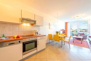 a kitchen and dining room with a table and chairs at Residenz Meeresblick D Fewo 111 in Rerik