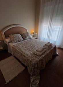 a bedroom with a bed with two pillows on it at Vivienda de uso turistico AT in Tomelloso