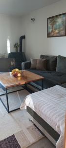 a living room with a coffee table and a couch at Pyramid Holiday House in Visoko