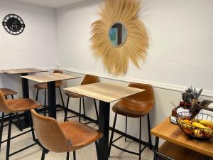 a room with tables and chairs and a mirror at Hôtel Le Mirage in Saintes-Maries-de-la-Mer