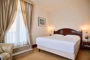Кровать или кровати в номере Arbiana Heritage Hotel