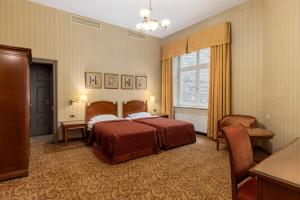 a hotel room with two beds and a window at The Benjamin House in Rīga