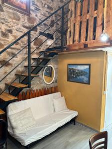 a white couch in a room with a staircase at Casa Curillas in Curillas