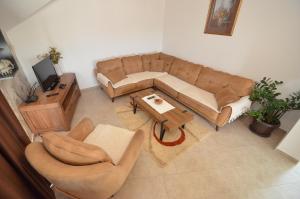 a living room with a couch and a table at Sun Apartment in Tivat