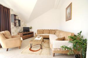 a living room with a couch and a table at Sun Apartment in Tivat