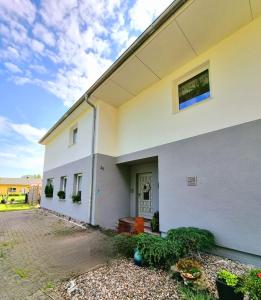 a white building with a window on the side of it at Haus Bärbel in Lietzow