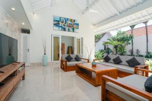 a living room with a couch and a table at Green Garden Seminyak Villa in Seminyak