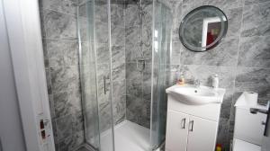 a bathroom with a shower and a sink at 59B Comfortable 3 Bedroom House By Easy 2 Manage in Cranford