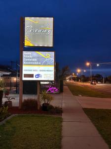 a sign for a dealership on the side of a street at Pevensey Motor Lodge in Echuca