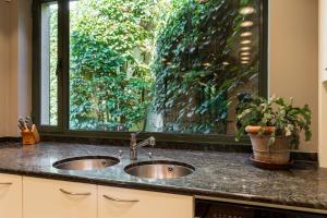 a kitchen counter with two sinks and a window at Villa Francine in Deinze