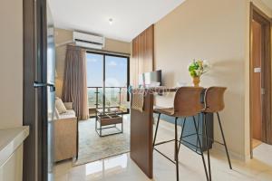 a room with a desk with a view of a living room at Caleido by Kozystay - BSD in Tangerang