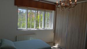 a room with a blue chair and a window at Casa de Lolo en Lariño cerca de la playa in San Mamede de Carnota