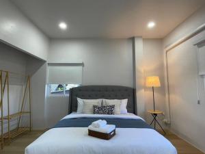 a bedroom with a large bed with a box on it at Prod Place - Sunny Chiang Rai in Chiang Rai