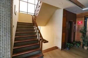 a staircase in a building with a window at FabHotel Narula in Dehradun
