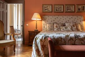 a bedroom with a bed and a chair and a lamp at The Benjamin House in Rīga