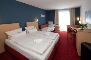 Postel nebo postele na pokoji v ubytování Hotel Mainpromenade ***S