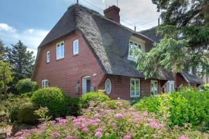 a red brick house with a gray roof at Deichgraf 2 in Kampen