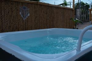 a bath tub filled with water next to a fence at Prince Apartments in Volissos