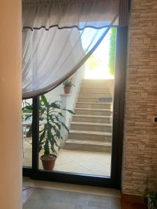 a door leading to a staircase with a curtain at B&B Villa Pietrachiara in Bari